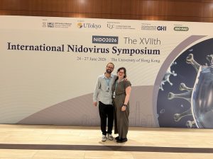 Max and Rebee in front of the Nido2026 Sign!